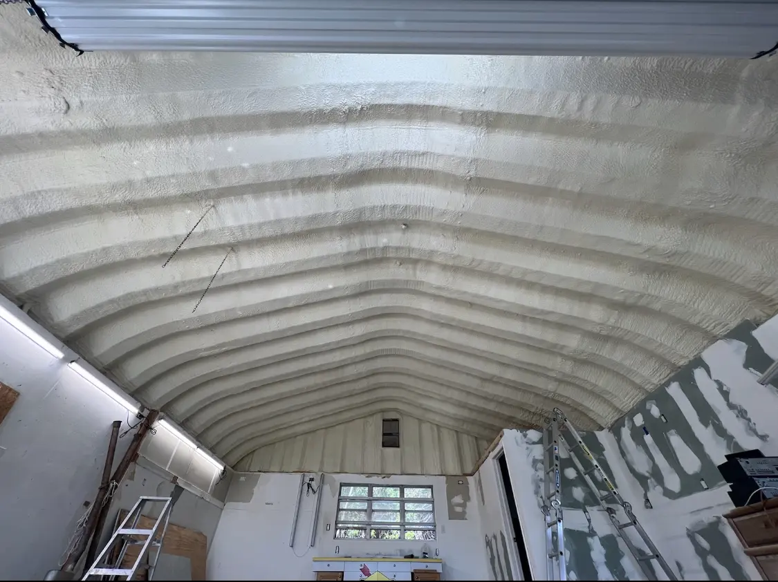 Spray polyurethane foam applied to the underside of a metal roof deck in Shakopee